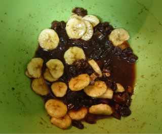 Banana relish with dried fruit in a green bowl
