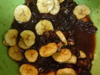 banana relish with dried fruit in a green bowl