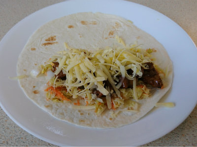 flour tortilla with chicken, pickled cabbage, and cheese