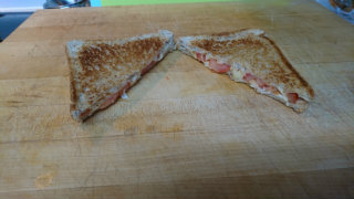 Grilled cheese with tomato cut in half