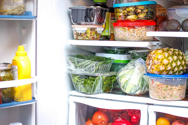 Open refrigerator with produce on the shelves