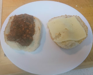 Open-faced sandwich with sloppy joes and a slice of cheese on top